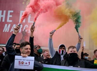 Manchester United fans storm pitch at Old Trafford in protest against the club's owners